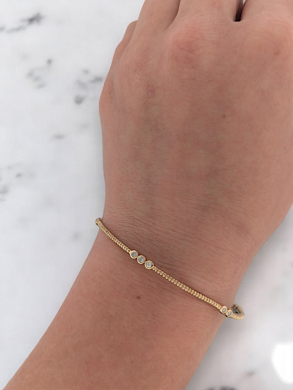 Elegant Sunniva bracelet in 14K yellow gold with .29ct natural diamonds, perfect for stacking or wearing solo, offering versatile day-to-night sophistication.