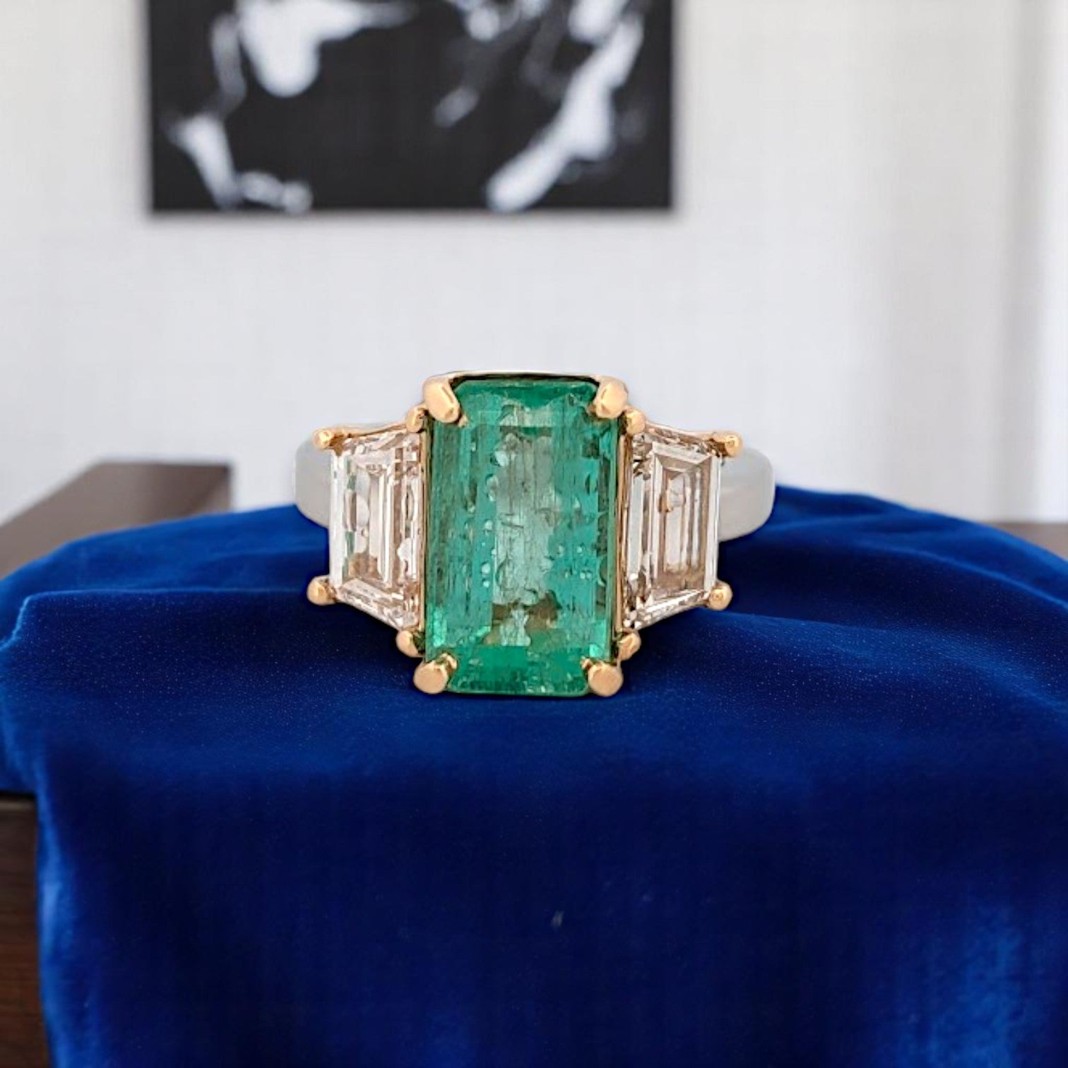 Platinum and 18k yellow gold ring featuring a 4.94 ct emerald-cut emerald and 6.98 ctw lab diamonds, size 6.25.