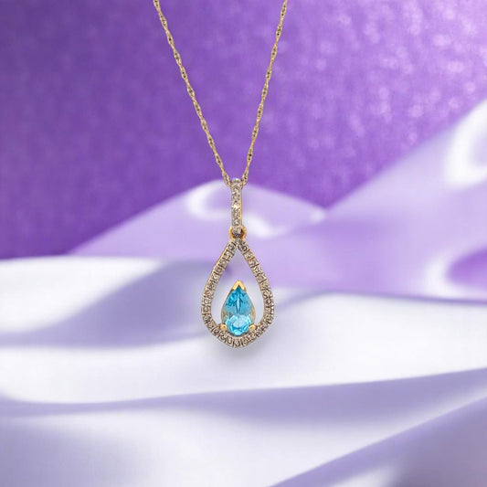 10k yellow gold pendant with pear shaped Swiss blue topaz and natural diamonds