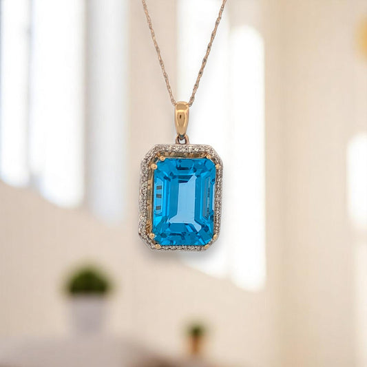14k yellow gold pendant with emerald cut blue topaz and natural diamonds