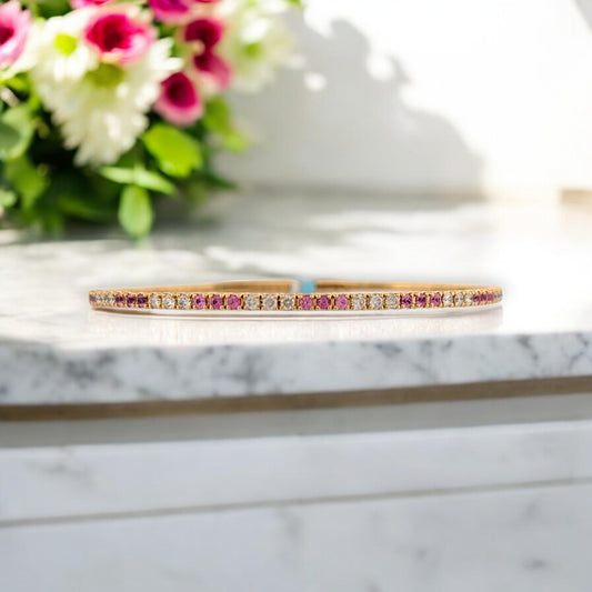 14k yellow gold flex bracelet with .55 ctw pink sapphires and .50 ctw round diamonds