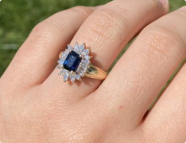 The Blountsville: Yellow Gold Emerald Cut Sapphire Ring with Shaped Diamond Halo