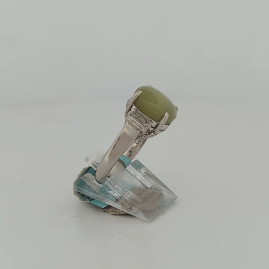 Luxury platinum engagement ring set with a unique cat's eye chrysoberyl and brilliant natural diamonds, embodying sophistication and elegance.