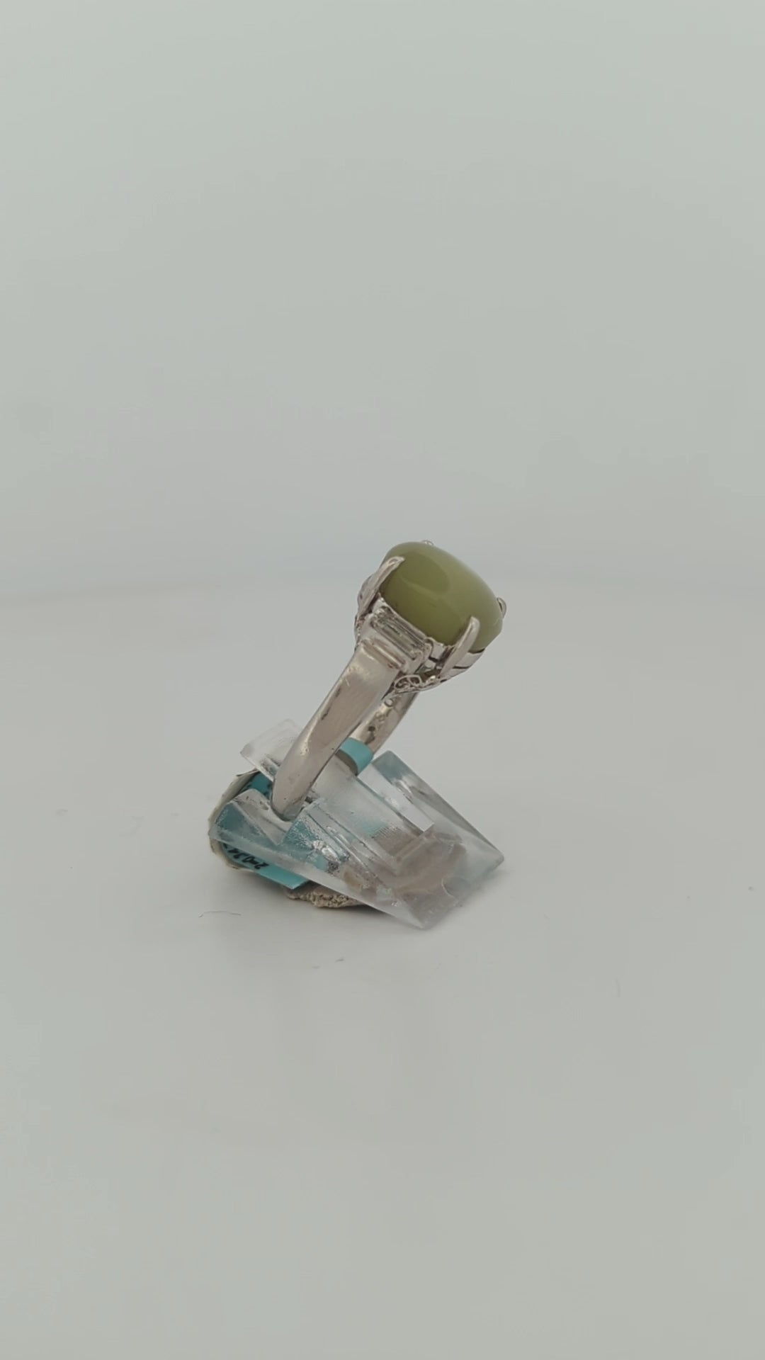 Luxury platinum engagement ring set with a unique cat's eye chrysoberyl and brilliant natural diamonds, embodying sophistication and elegance.